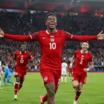 Canada vs Qatar FIFA World Cup 2026 Match Update showing Jonathan David celebrating after scoring during Canada's historic 6-0 victory over Qatar